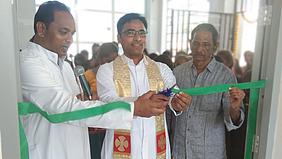 Pfarrer Chinnapa Reddy Allam durchtrennt das grüne Band zum Computerraum.